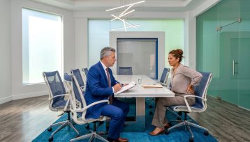 Woman with hip pain after fall at business speaking with California trial attorney