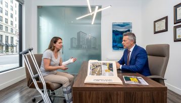 injured person after slipping on floor at business speaking with lawyer